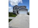 Charming two-story home with gray siding, black shutters, manicured lawn, and a two-car garage at 1715 Perthshire Loop, Myrtle Beach, SC 29579