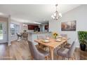 Bright dining area with a wooden table set for six and an open view of the kitchen at 219 Blackpepper Loop, Little River, SC 29566