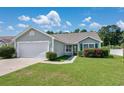 Inviting single-story home with green shutters, a well-kept lawn, and a two-car garage at 219 Blackpepper Loop, Little River, SC 29566