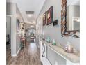 Bright hallway with wood-look floors and neutral walls showcasing decorative shelving and access to living areas at 227 Palm Terrace Loop, Conway, SC 29526