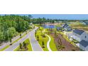 An aerial view of the community featuring a serene pond with a fountain and lush greenery, offering a peaceful setting at 2273 Hazel Way, Longs, SC 29568