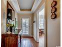 Elegant hallway with hardwood floors and decorative wall accents that leads to sunlit rooms at 2450 Marsh Glen Dr. # 112, North Myrtle Beach, SC 29582