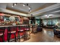 Spacious living room with a custom bar, a cozy seating area, and hardwood floors at 2450 Marsh Glen Dr. # 112, North Myrtle Beach, SC 29582