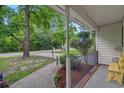 Relaxing porch view with hanging plants, a cozy bench, and a view of the serene street at 311 Ashwood Ln., Myrtle Beach, SC 29588