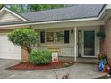 Inviting covered porch with charming decor, potted plants, and a cozy atmosphere at 311 Ashwood Ln., Myrtle Beach, SC 29588