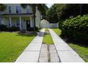 Long driveway leading to a fenced backyard and detached garage, with a well-maintained lawn at 433 Emerson Dr., Myrtle Beach, SC 29579