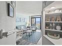 Living room with beach decor, including a couch, chair, and a view of the ocean from the balcony at 4800 S Ocean Blvd. # 520, North Myrtle Beach, SC 29582