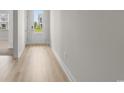 Bright entryway with hardwood floors and white trim, leading to a sunlit view at 490 Calhoun Falls Dr., Myrtle Beach, SC 29579