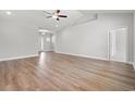 Spacious living room featuring soaring ceilings, natural light, and attractive wood-look flooring at 5009 Shore Breeze Dr., Myrtle Beach, SC 29588