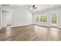 Bright living room with hardwood floors, a ceiling fan, recessed lights, and ample natural light at 5164 Water Breeze Ct., Myrtle Beach, SC 29588