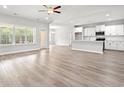 Open-concept living space with hardwood floors that flows into the kitchen at 5164 Water Breeze Ct., Myrtle Beach, SC 29588