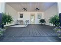 Inviting covered porch with comfortable seating, ferns, ceiling fans, and a bright yellow door at 518 Nowell St., Georgetown, SC 29440
