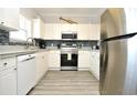 Bright kitchen with stainless appliances, white cabinets, and stylish backsplash at 5825 Catalina Dr. # 833, North Myrtle Beach, SC 29582