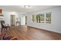 Open-concept living room featuring hardwood floors and large windows for ample natural light at 602 3Rd Ave. N, Myrtle Beach, SC 29577