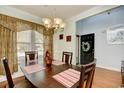 Cozy dining room with a wooden table set for four and a view of the front entrance at 6172 Catalina Dr. # 113, North Myrtle Beach, SC 29582