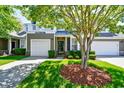 Inviting two-story townhome with attached garage, balcony, and beautiful, lush front lawn at 6172 Catalina Dr. # 113, North Myrtle Beach, SC 29582