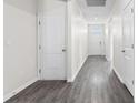 Bright hallway featuring gray wood floors, white doors and walls, plus recessed lighting at 1128 Sennema Circle, Myrtle Beach, SC 29588