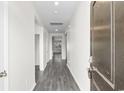 Inviting hallway with modern gray wood floors, white walls, and recessed lighting at 1128 Sennema Circle, Myrtle Beach, SC 29588