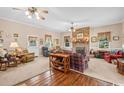Cozy living room with brick fireplace, carpet flooring, and large windows providing natural light at 12721 Pleasant Hill Dr., Hemingway, SC 29554