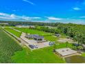 Aerial view of a well-maintained property featuring a house, multiple outbuildings, and mature landscaping at 15810 County Line Rd., Andrews, SC 29510