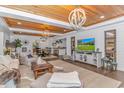 Comfortable living room featuring stylish decor, wood ceiling, and an open layout with seamless flow to the dining area at 15810 County Line Rd., Andrews, SC 29510