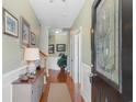 Inviting entryway featuring hardwood floors, fresh paint, decorative molding, and a charming console table at 178 Parmalee Dr. # C, Murrells Inlet, SC 29576