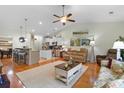 Bright, open-concept living room with hardwood floors, ceiling fan, and seamless flow to the kitchen at 178 Parmalee Dr. # C, Murrells Inlet, SC 29576