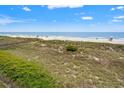 Scenic beach view with grassy dunes and a boardwalk access, perfect for serene coastal living at 1820 N Ocean Blvd. # 303D, North Myrtle Beach, SC 29582