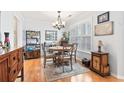 Dining room featuring wood floors, a chandelier, and plenty of natural light at 208 Millwood Dr., Surfside Beach, SC 29575
