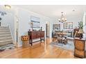 Open dining area with a chandelier, wood floors, storage and natural light at 208 Millwood Dr., Surfside Beach, SC 29575