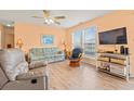 Cozy living room with comfortable seating, a ceiling fan, and a large window with natural light at 212 29Th Ave. N # 204, North Myrtle Beach, SC 29582