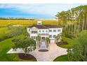 Beautiful home with view to beach, lush lawn, mature trees, and long driveway at 288 Tipperary Pl., Pawleys Island, SC 29585