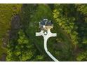 A high angle picture of a home surrounded by lush lawn and dense trees and with a curved driveway at 288 Tipperary Pl., Pawleys Island, SC 29585