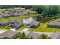Aerial view of a lovely home overlooking a serene pond with fountain in a vibrant community at 305 Forestbrook Cove Circle, Myrtle Beach, SC 29588