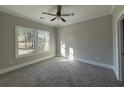 Cozy bedroom with plush carpeting, ceiling fan and a bright window offering natural light at 3139 Tiger Tail Rd., Conway, SC 29526