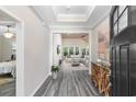 Bright foyer featuring wood-look flooring, high ceilings, and an open view into the living room at 3647 Diamond Stars Way, Little River, SC 29566