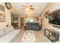 Spacious living room with wood floors, vaulted ceiling, TV, and furniture with dining area view at 3879 Mallard Way, Little River, SC 29566
