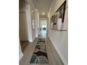 Inviting hallway with light wood floors, contemporary rugs, and stylish decor at 435 Rollins Dr., Longs, SC 29568