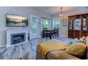 Cozy living area featuring a fireplace, dining set, and natural light at 4355 Rivergate Ln. # F, Little River, SC 29566