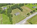 Expansive aerial view of a single story home with a spacious yard surrounded by lush greenery at 580 Circle M Rd., Longs, SC 29568