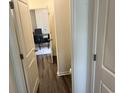 Hallway leading to an office with desk, plush chairs, and stylish decor creating a professional atmosphere at 606 Muster Field Ct., Conway, SC 29526