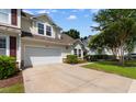 Charming two-story home features a white garage door, nicely landscaped yard, and light yellow siding at 6095 Catalina Dr. # 616, North Myrtle Beach, SC 29582