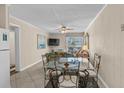 Bright living and dining area with tile floors and access to a balcony with ocean views at 6301 N Ocean Blvd. # 2B, North Myrtle Beach, SC 29582