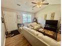 Cozy living room showcasing wood floors, neutral tones, and natural light at 706 Jamie Ln., Conway, SC 29526