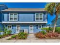 Inviting two-story condo featuring lovely landscaping with a pop of colorful flowers at 832 Villa Dr. # 832, North Myrtle Beach, SC 29582