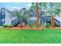 Low-angle, eye-level view of a condo exterior with stairs, green shutters, and landscaped grounds at 850 Fairway Dr. # 904Ee, Longs, SC 29568