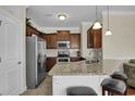 Modern kitchen featuring stainless steel appliances, granite countertops, and breakfast bar seating at 8855 Radcliff Dr. Nw # 50B, Calabash, NC 28467