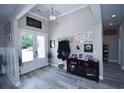 Inviting foyer with light gray plank flooring, white trim, and decorative wall decor at 1455 Whooping Crane Dr., Conway, SC 29526