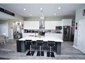 Spacious kitchen featuring a large island with seating, white cabinets, and stainless steel appliances at 1455 Whooping Crane Dr., Conway, SC 29526