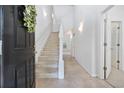 Bright foyer with stairway, high ceilings, and a combination of tile and carpet flooring at 155 Chenoa Dr. # D, Murrells Inlet, SC 29576